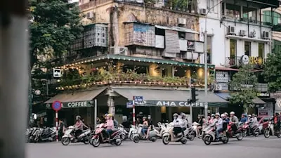 people riding motorcycle on road near building during daytime · 지역 전경, 숙소 사진 아님